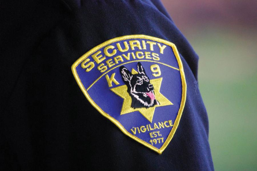 blue shoulder patch that says security services with german shephard dog