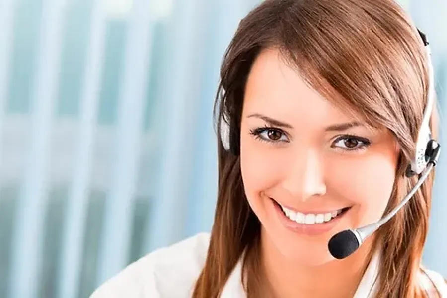 woman smiling at camera wearing phone headset