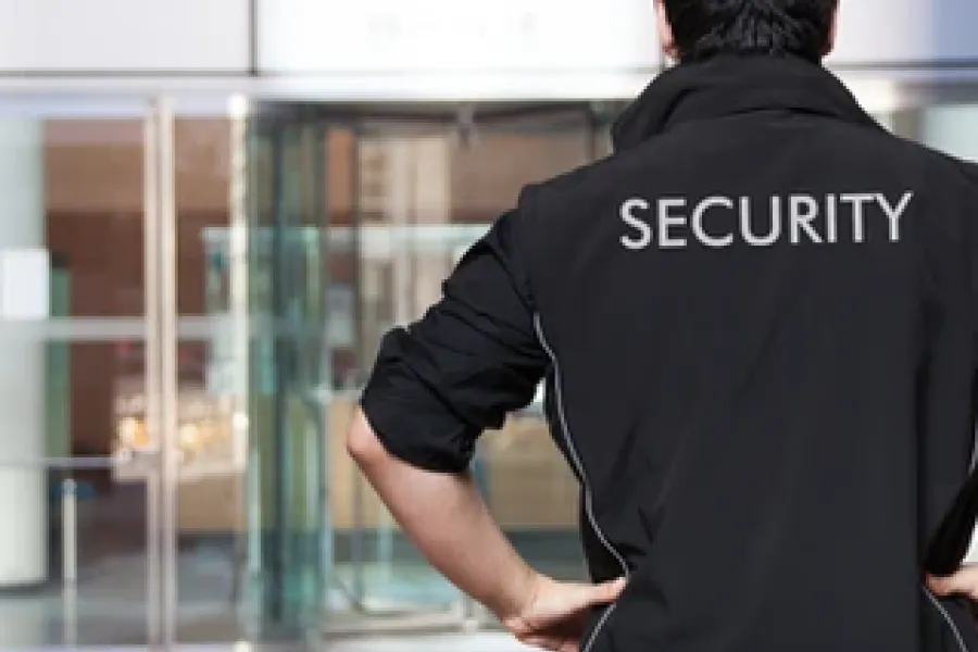 back of security guard with word security written on back of jacket