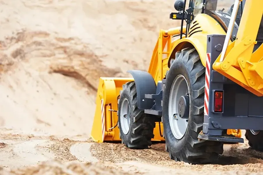 construction vehicle moves dirt on job site