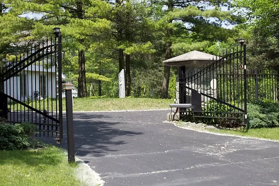 driveway gates open to a gated community