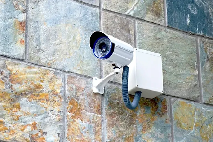 security camera on building outside pointed toward left