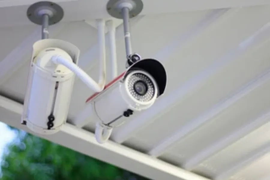 security camera hanging outside from roof