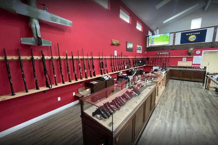 long guns leaning against red wall