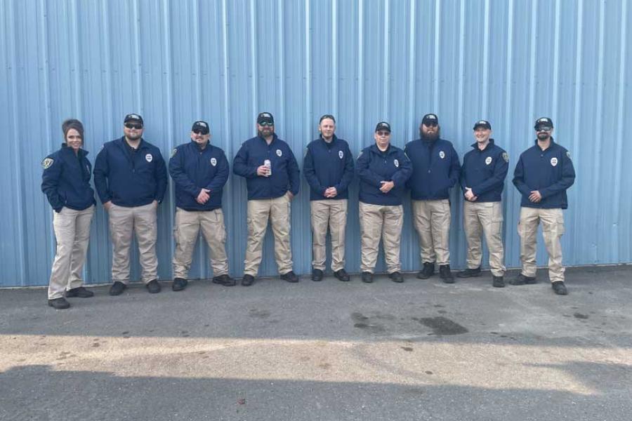 group of nine officers standing in a row