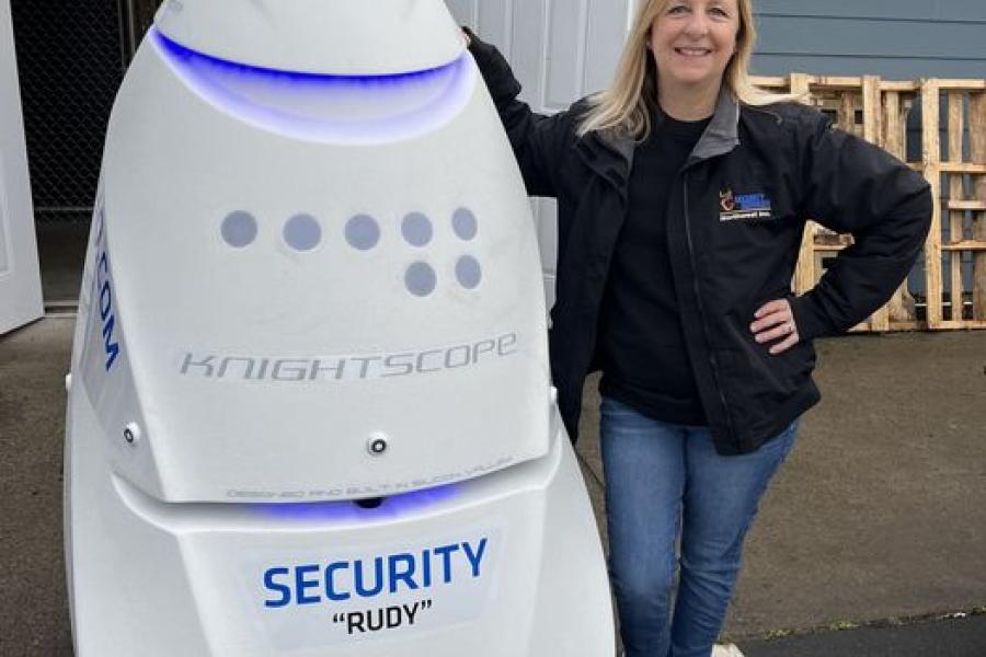 jamie stands beside rudy the robot