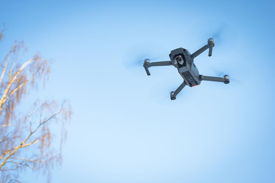 drone flying against blue sky
