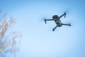drone flying against blue sky