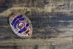 close up of security officer badge on wood background