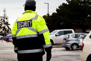 security officer watching over vehicles in parking lot 