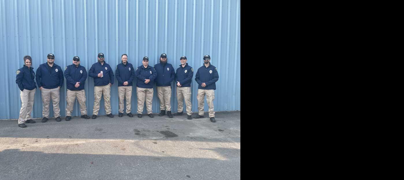 group of nine officers standing in a row