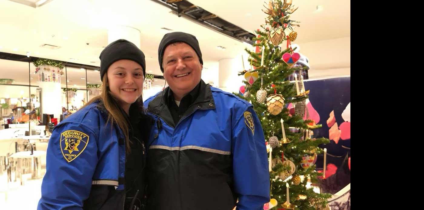 male and female security officers in blue coats