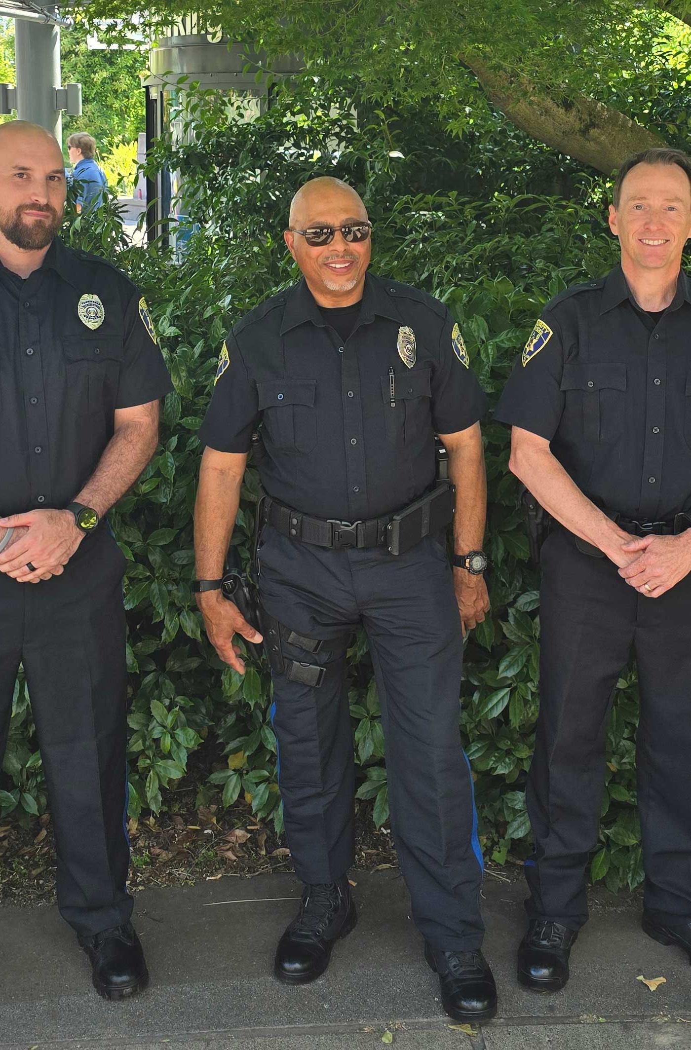 three ssnw officers in uniform standing outside