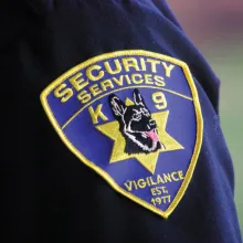 blue shoulder patch that says security services with german shephard dog