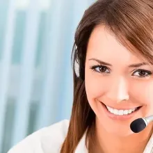 woman smiling at camera wearing phone headset