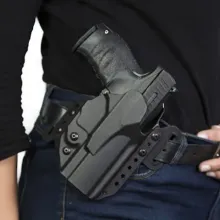 close up of side view of armed security guard
