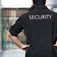 back of security guard with word security written on back of jacket