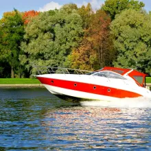 red and white boat zipping by on water