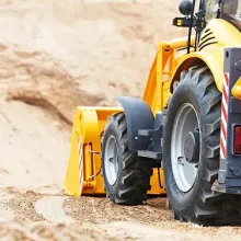 construction vehicle moves dirt on job site