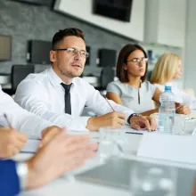 group of people sitting at desk in a business meeting
