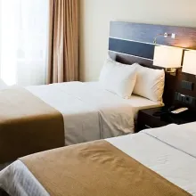 two freshly made beds in hotel room