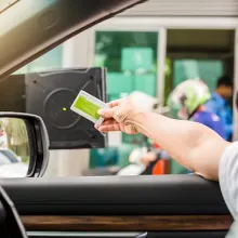 passenger in vehicle scanning card at parking lot