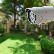 security camera outside with family home in background