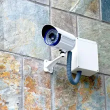 security camera on building outside pointed toward left