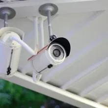 security camera hanging outside from roof
