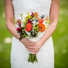 bride in white dress holding bouquet of flowers