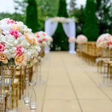 chairs and flowers set up for wedding ceremony; view of looking down aisle