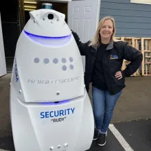 jamie stands beside rudy the robot