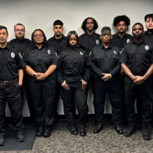 group of 12 officers standing in office