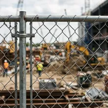 construction site behind chain link fence