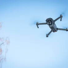 drone flying against blue sky