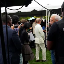 security officer observing outdoor gathering under tent