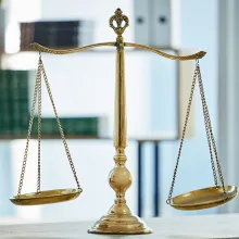 gold justice scales on desk