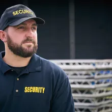male security officer standing outside by stage