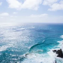 ocean waves crashing against a rocky shoreline