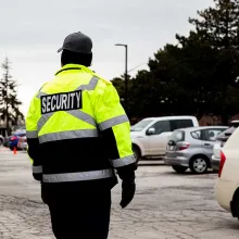 security officer watching over vehicles in parking lot 
