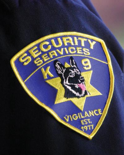 blue shoulder patch that says security services with german shephard dog