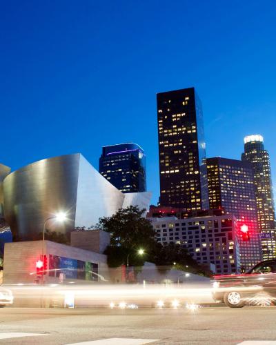 cityview of downtown los angeles with skyscrapers, blurred cars, and street lights