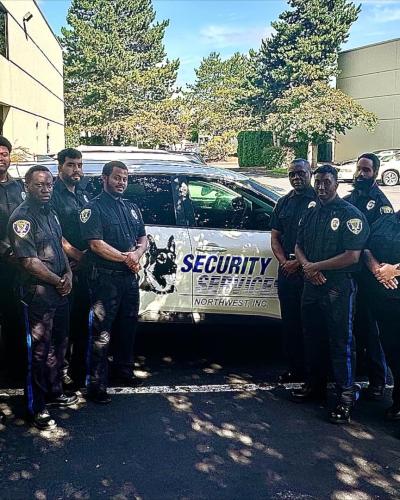 group of security officers in front of patrol vehicle