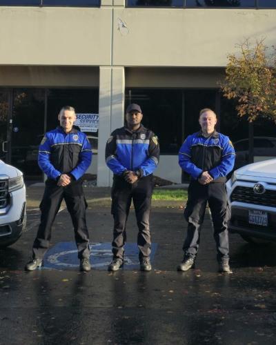 three officers and two vehicles outside office