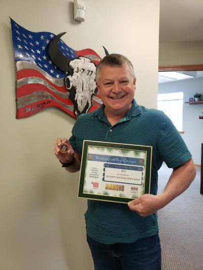 joe holding diamond award and coin from daughters of the american revolution