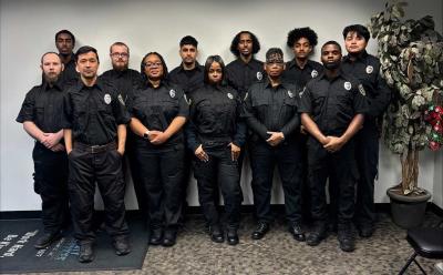 group of 12 officers standing in office